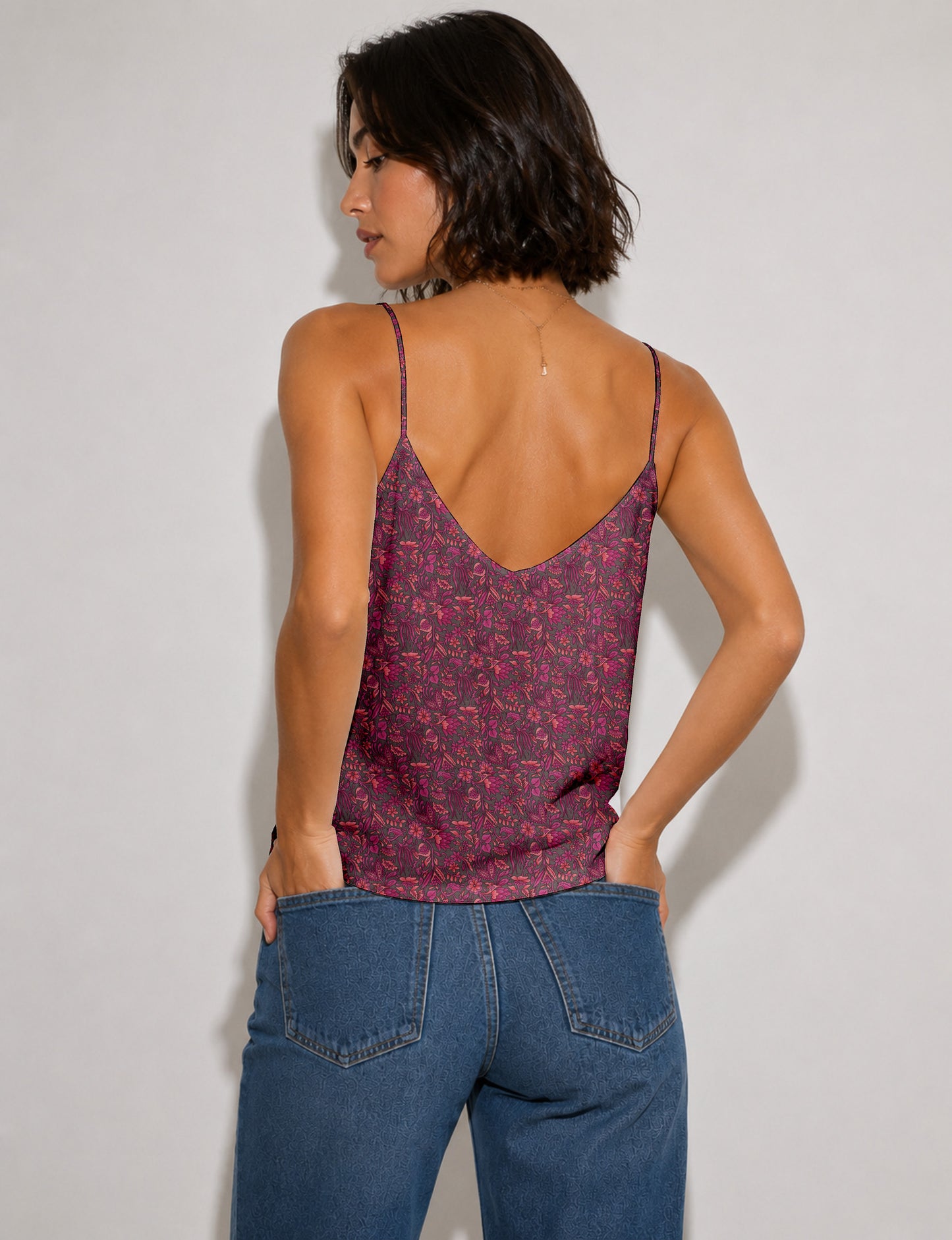 Women's sleeveless slip top with a relaxed straight fit, soft V-neckline, deep V-back, and delicate spaghetti straps.