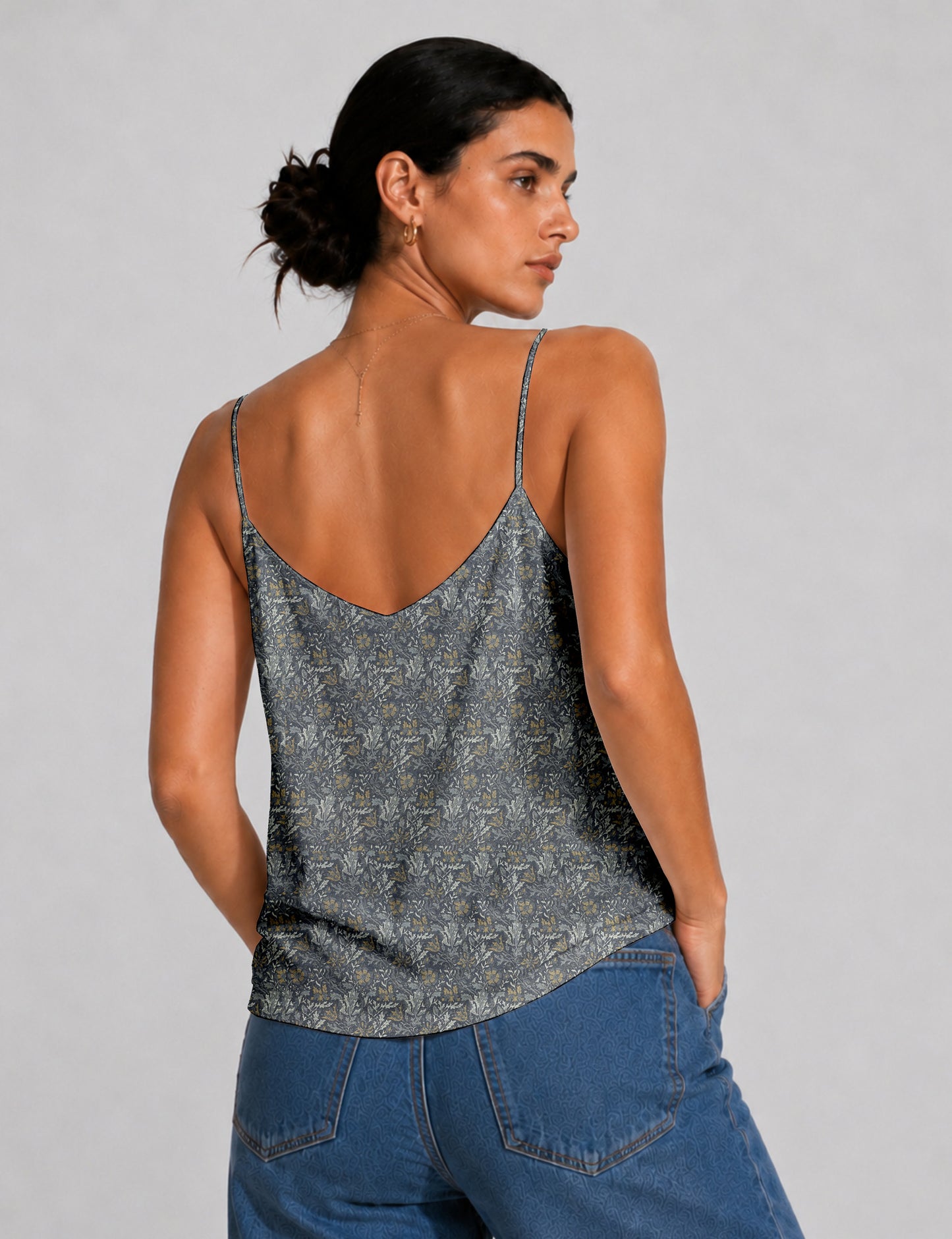 Women's sleeveless slip top with a relaxed straight fit, soft V-neckline, deep V-back, and delicate spaghetti straps.