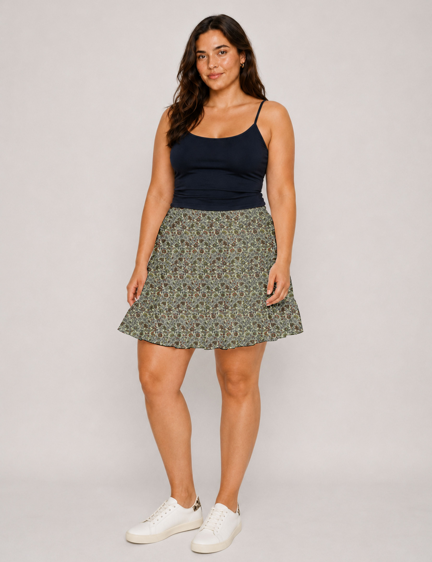 Short tiered skirt with a fitted waistband, knife pleats, softly flared silhouette, side seam pockets, and above-the-knee length.