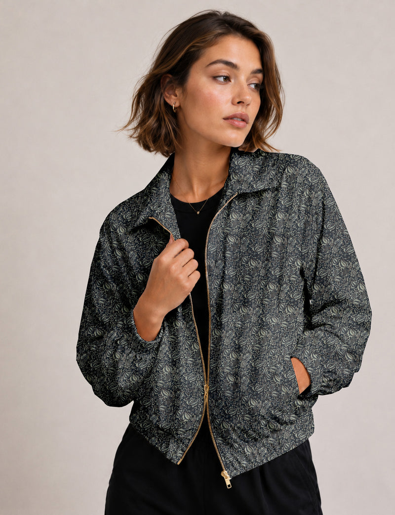 Brown floral bomber jacket with front zipper, elastic cuffs and hem, hanging on white hanger, red floral inner lining visible