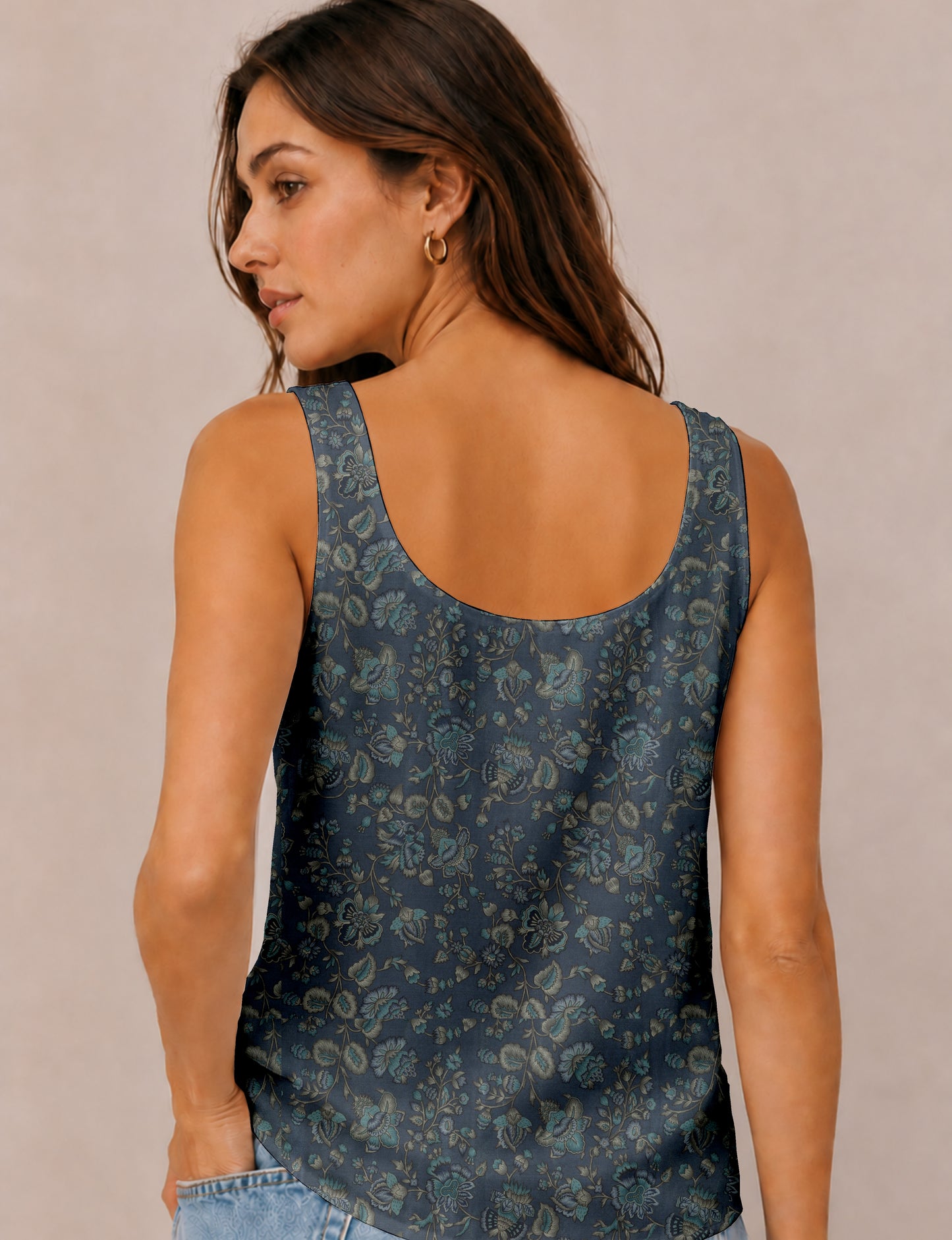 Women's sleeveless blouse with a relaxed straight fit, wide scoop neckline, deep scoop back, and hip-length silhouette.