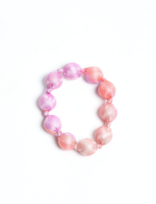 Eco friendly beaded knotted bracelet crafted from upcycled women’s clothing and repurposed sari fabrics, showcasing circular fashion and sustainable apparel.