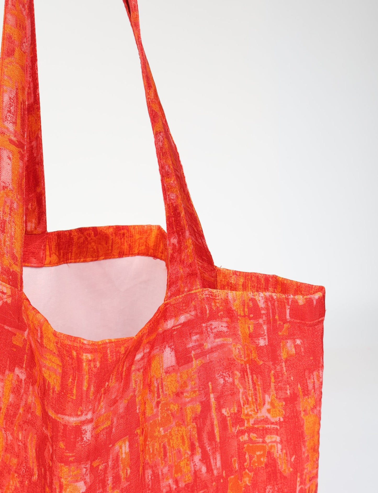 Colorful shopper bag made from recycled sari fabric, representing eco clothing, sustainable women's clothing, carbon neutral fashion, and repurposed clothing — ideal for environmentally friendly lifestyles and conscious clothing choices.