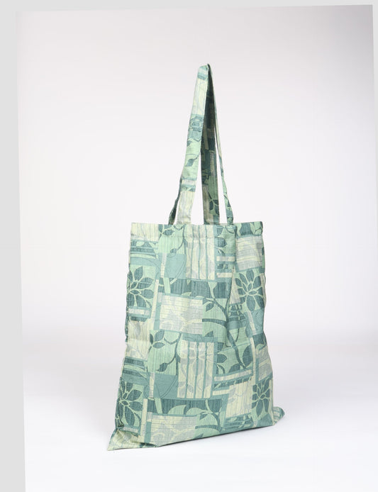 Colorful shopper bag made from recycled sari fabric, representing eco clothing, sustainable women's clothing, carbon neutral fashion, and repurposed clothing — ideal for environmentally friendly lifestyles and conscious clothing choices.
