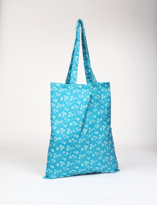 Colorful shopper bag made from recycled sari fabric, representing eco clothing, sustainable women's clothing, carbon neutral fashion, and repurposed clothing — ideal for environmentally friendly lifestyles and conscious clothing choices.