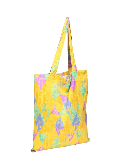 Colorful shopper bag made from recycled sari fabric, representing eco clothing, sustainable women's clothing, carbon neutral fashion, and repurposed clothing — ideal for environmentally friendly lifestyles and conscious clothing choices.