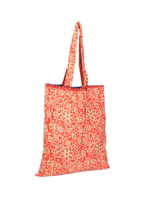 Colorful shopper bag made from recycled sari fabric, representing eco clothing, sustainable women's clothing, carbon neutral fashion, and repurposed clothing — ideal for environmentally friendly lifestyles and conscious clothing choices.