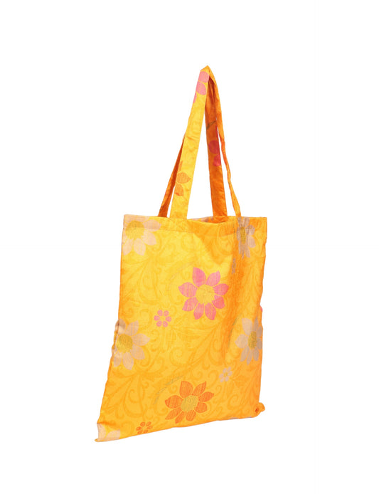 Colorful shopper bag made from recycled sari fabric, representing eco clothing, sustainable women's clothing, carbon neutral fashion, and repurposed clothing — ideal for environmentally friendly lifestyles and conscious clothing choices.