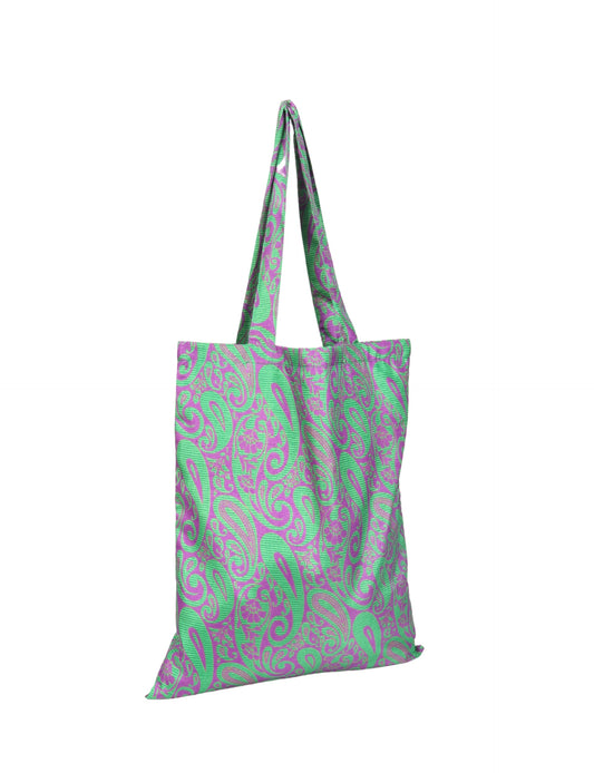 Colorful shopper bag made from recycled sari fabric, representing eco clothing, sustainable women's clothing, carbon neutral fashion, and repurposed clothing — ideal for environmentally friendly lifestyles and conscious clothing choices.