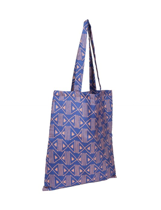 Colorful shopper bag made from recycled sari fabric, representing eco clothing, sustainable women's clothing, carbon neutral fashion, and repurposed clothing — ideal for environmentally friendly lifestyles and conscious clothing choices.