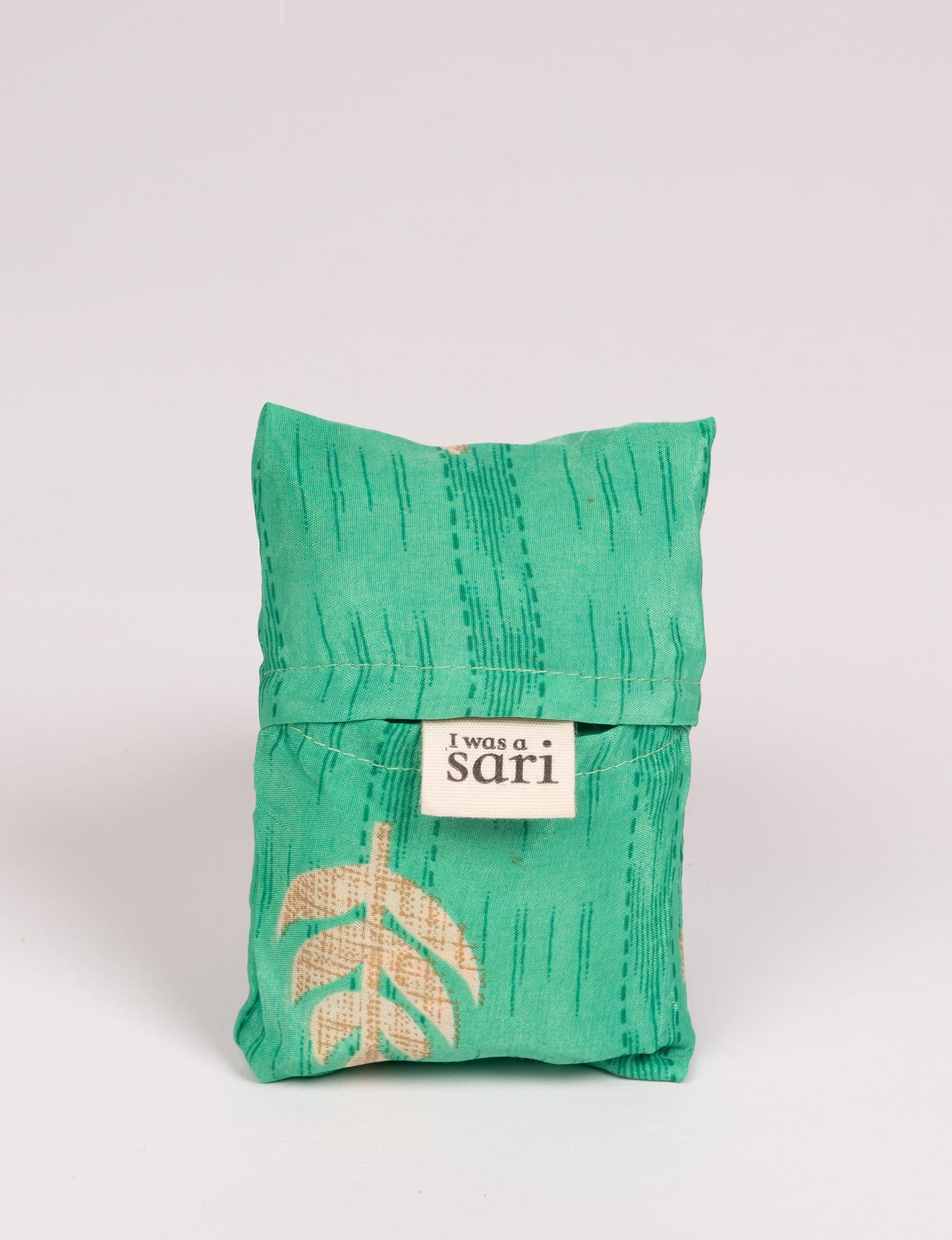 Stay eco-conscious with our Reusable Bag, handmade by Indian artisans from pre-loved saris. Silky and lightweight, this foldaway bag is perfect for your on-the-go lifestyle. Each piece is a unique statement of ethical fashion, embracing sustainability and style.