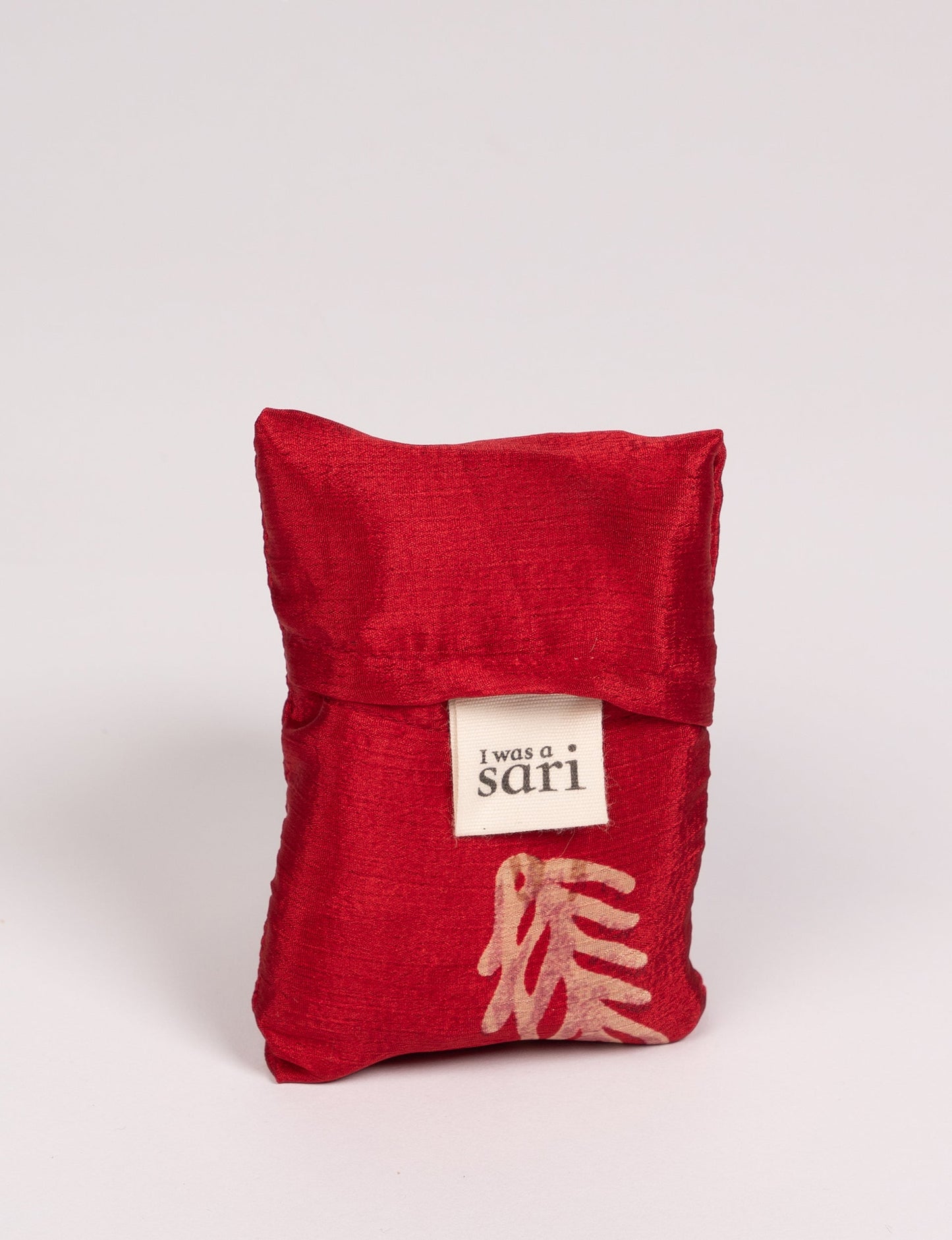 Stay eco-conscious with our Reusable Bag, handmade by Indian artisans from pre-loved saris. Silky and lightweight, this foldaway bag is perfect for your on-the-go lifestyle. Each piece is a unique statement of ethical fashion, embracing sustainability and style.