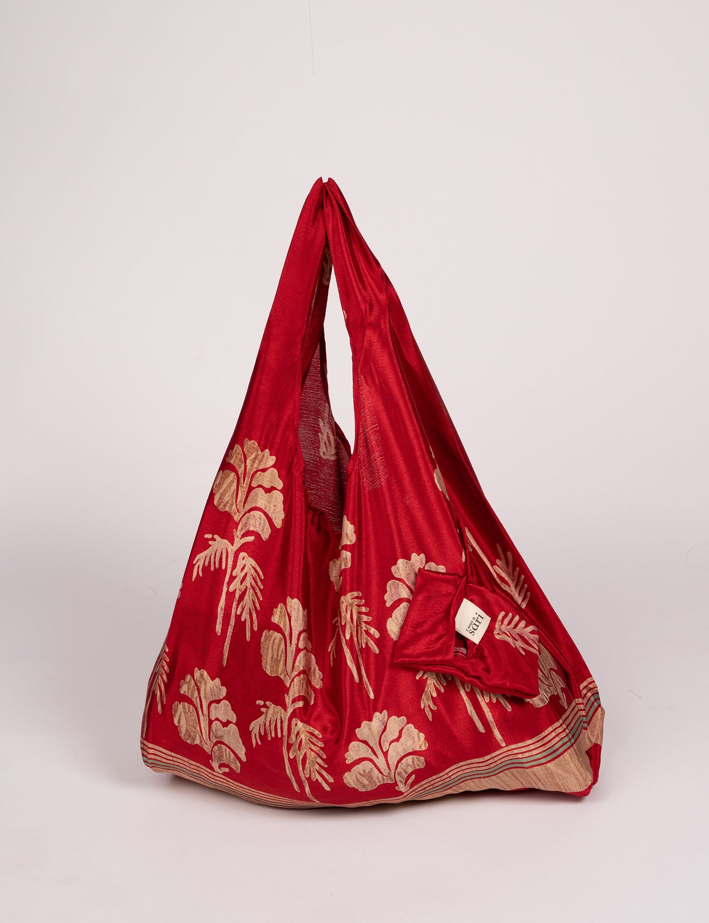 Stay eco-conscious with our Reusable Bag, handmade by Indian artisans from pre-loved saris. Silky and lightweight, this foldaway bag is perfect for your on-the-go lifestyle. Each piece is a unique statement of ethical fashion, embracing sustainability and style.