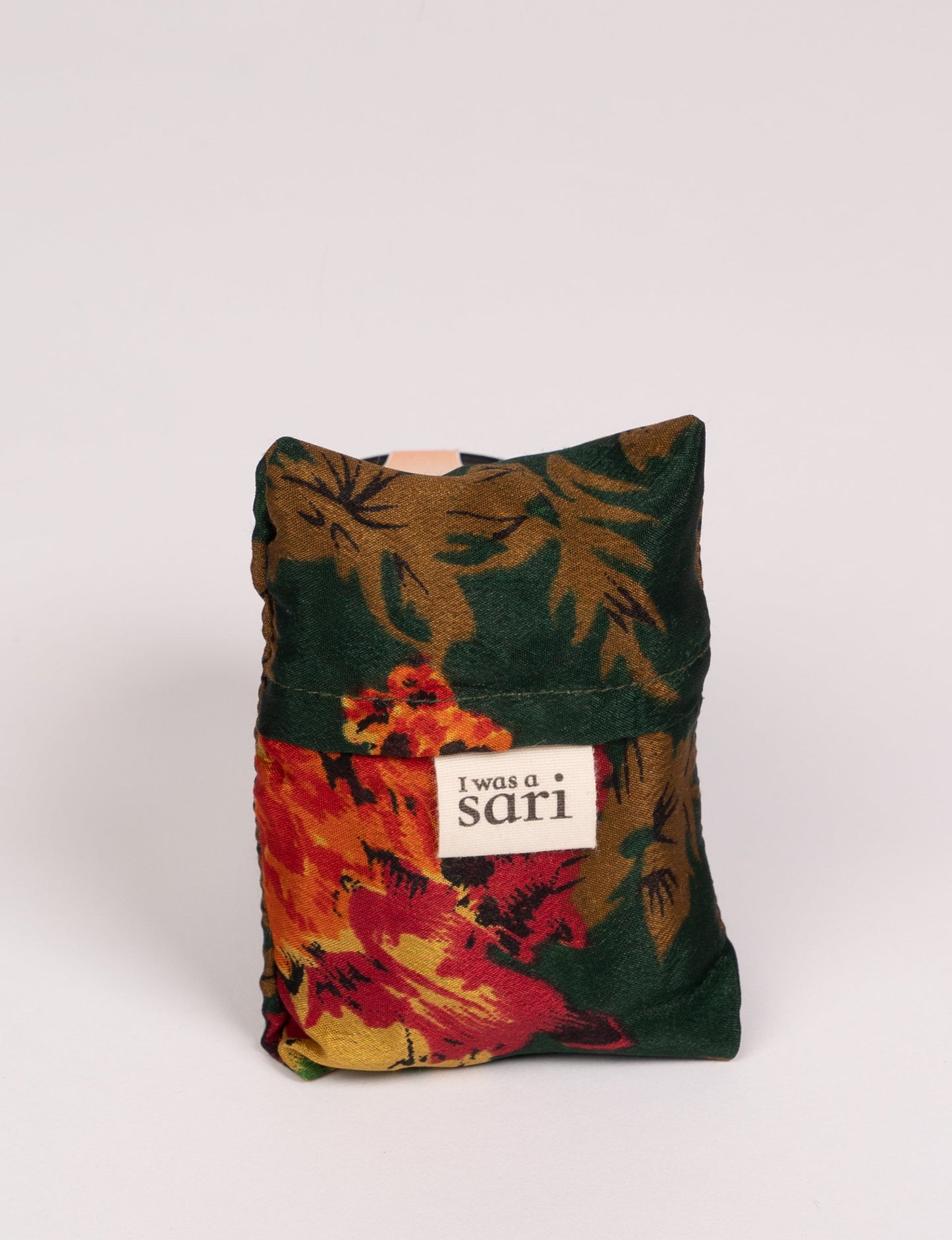 Stay eco-conscious with our Reusable Bag, handmade by Indian artisans from pre-loved saris. Silky and lightweight, this foldaway bag is perfect for your on-the-go lifestyle. Each piece is a unique statement of ethical fashion, embracing sustainability and style.