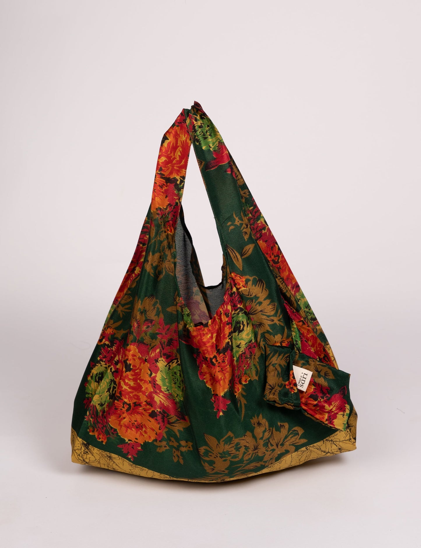 Stay eco-conscious with our Reusable Bag, handmade by Indian artisans from pre-loved saris. Silky and lightweight, this foldaway bag is perfect for your on-the-go lifestyle. Each piece is a unique statement of ethical fashion, embracing sustainability and style.