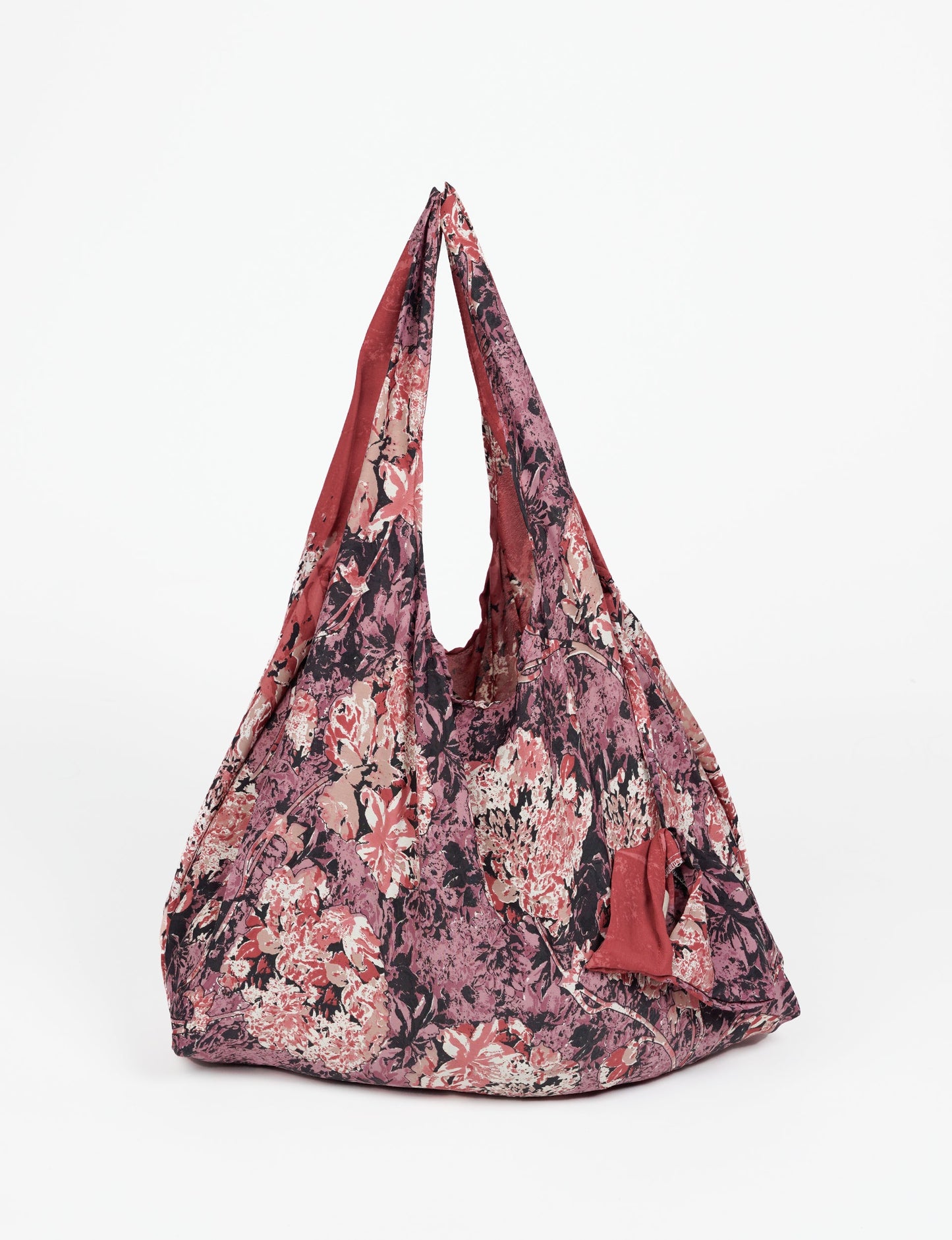 Stay eco-conscious with our Reusable Bag, handmade by Indian artisans from pre-loved saris. Silky and lightweight, this foldaway bag is perfect for your on-the-go lifestyle. Each piece is a unique statement of ethical fashion, embracing sustainability and style.