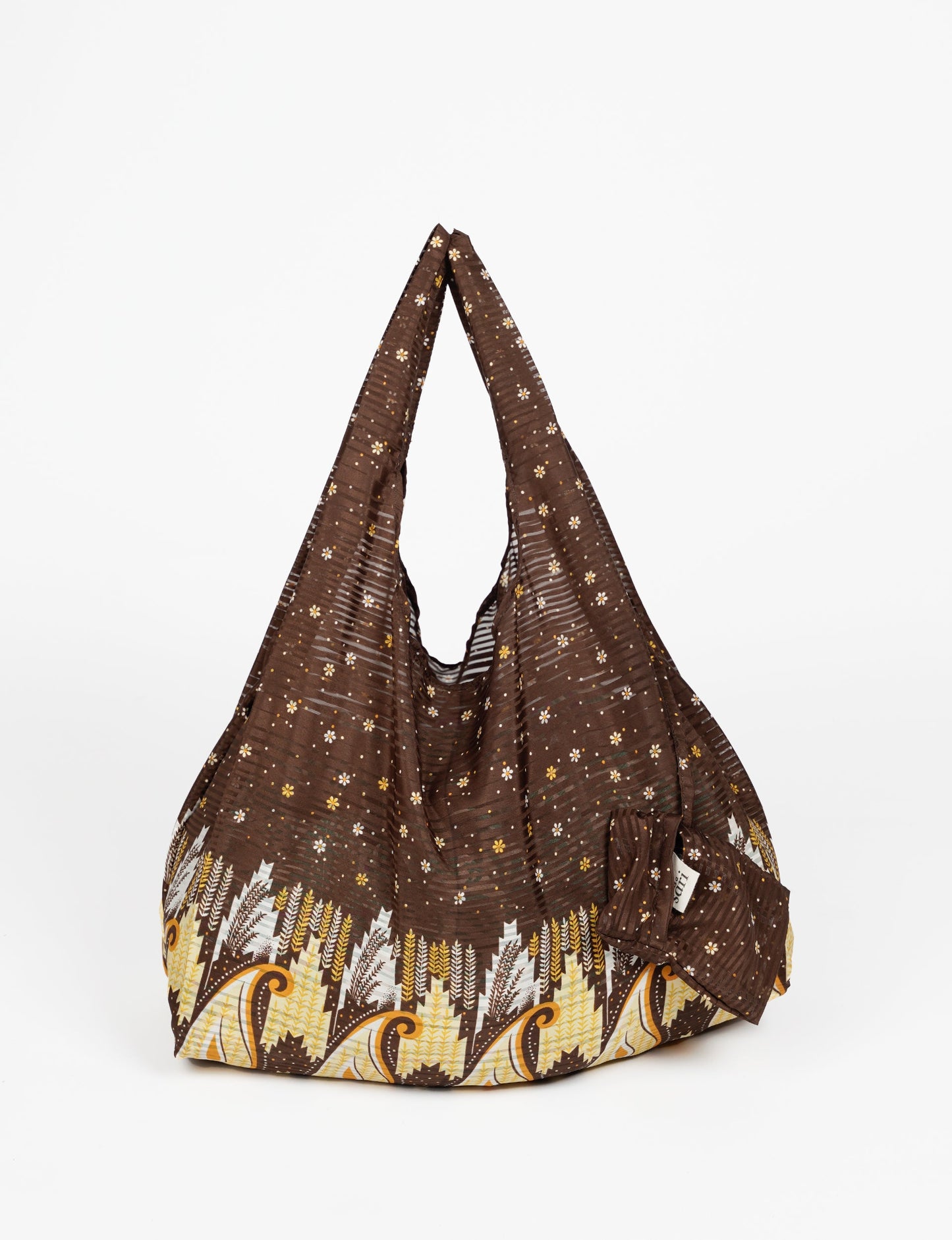 Stay eco-conscious with our Reusable Bag, handmade by Indian artisans from pre-loved saris. Silky and lightweight, this foldaway bag is perfect for your on-the-go lifestyle. Each piece is a unique statement of ethical fashion, embracing sustainability and style.