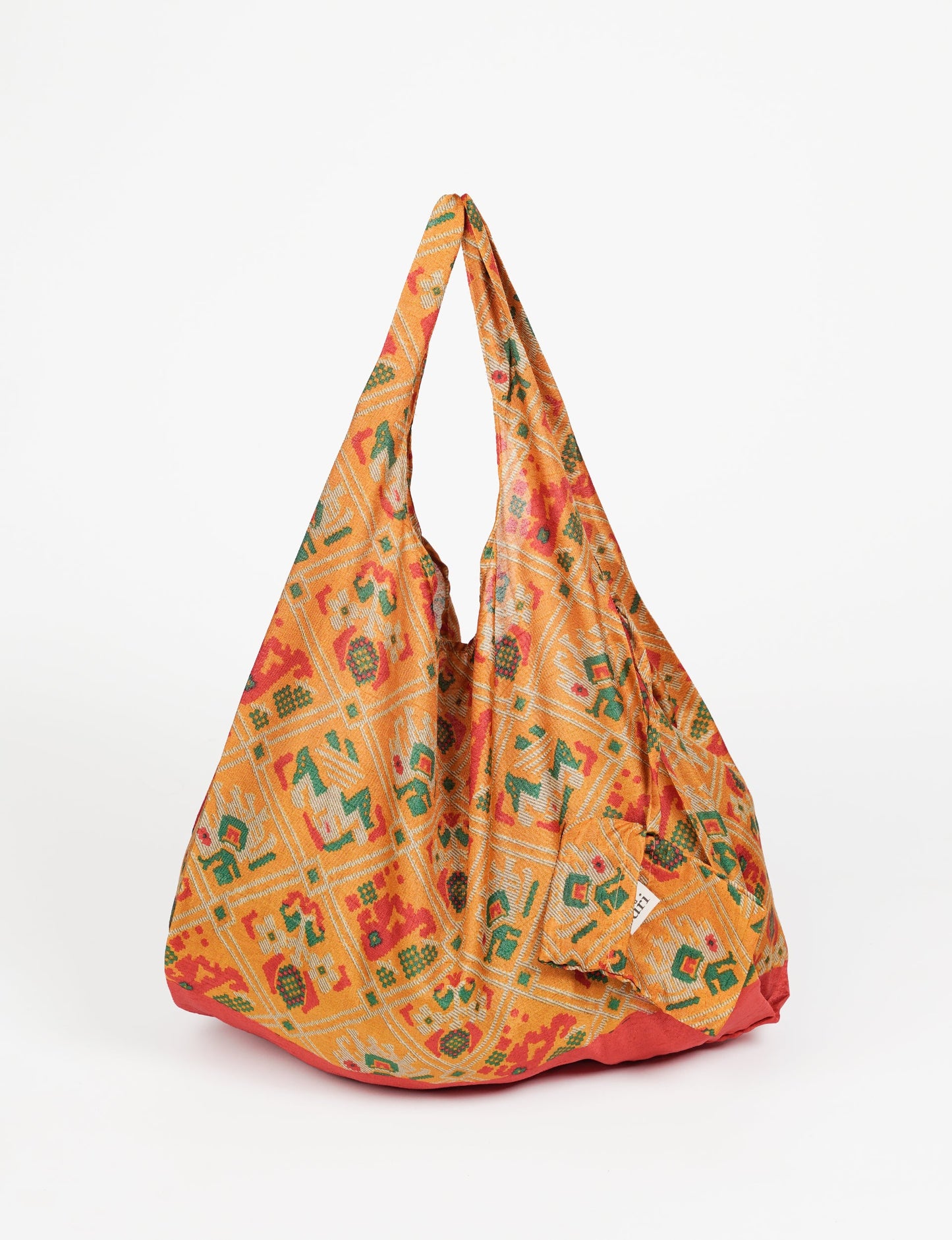 Stay eco-conscious with our Reusable Bag, handmade by Indian artisans from pre-loved saris. Silky and lightweight, this foldaway bag is perfect for your on-the-go lifestyle. Each piece is a unique statement of ethical fashion, embracing sustainability and style.