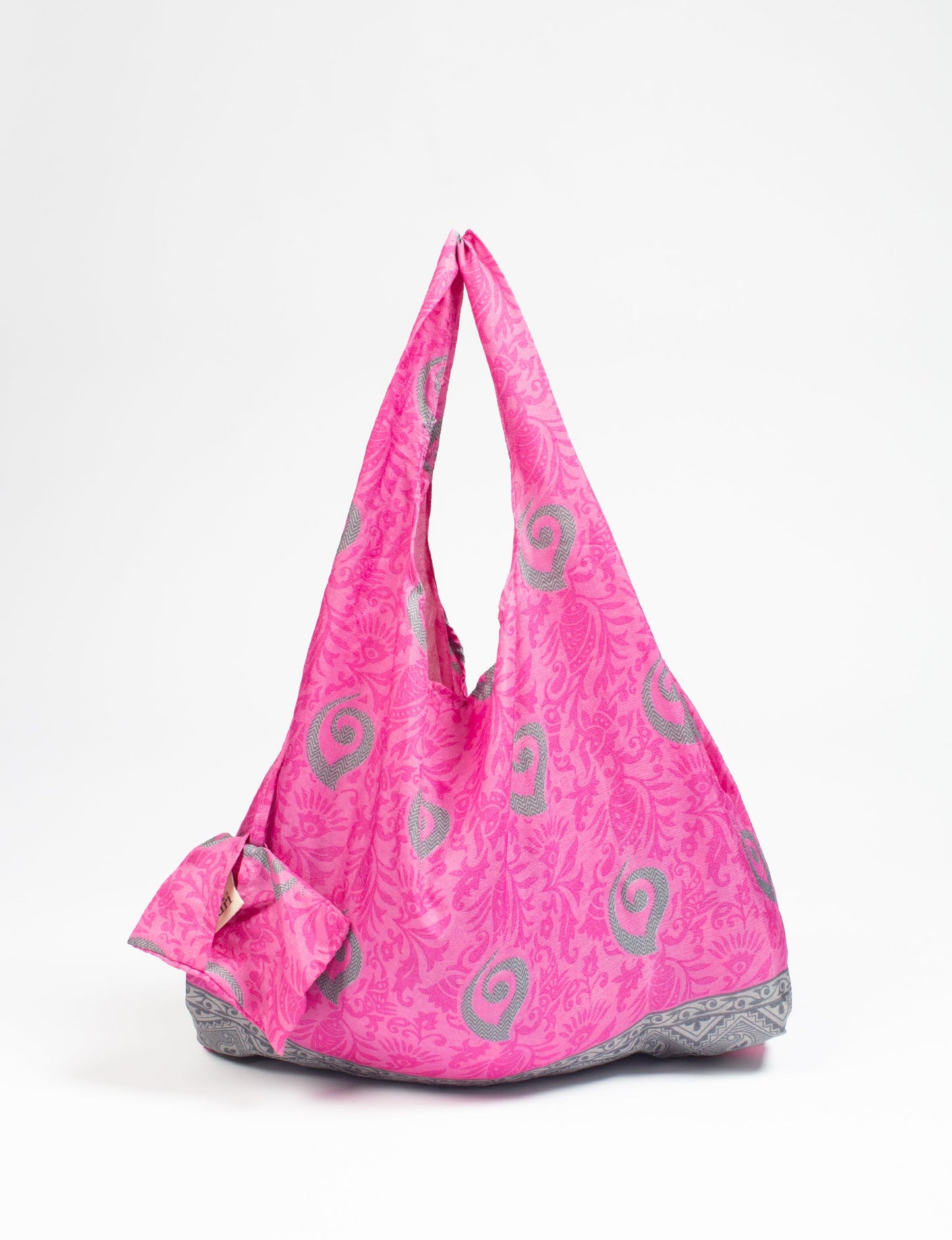 Stay eco-conscious with our Reusable Bag, handmade by Indian artisans from pre-loved saris. Silky and lightweight, this foldaway bag is perfect for your on-the-go lifestyle. Each piece is a unique statement of ethical fashion, embracing sustainability and style.