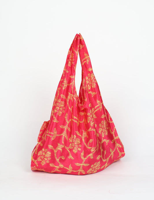 Stay eco-conscious with our Reusable Bag, handmade by Indian artisans from pre-loved saris. Silky and lightweight, this foldaway bag is perfect for your on-the-go lifestyle. Each piece is a unique statement of ethical fashion, embracing sustainability and style.