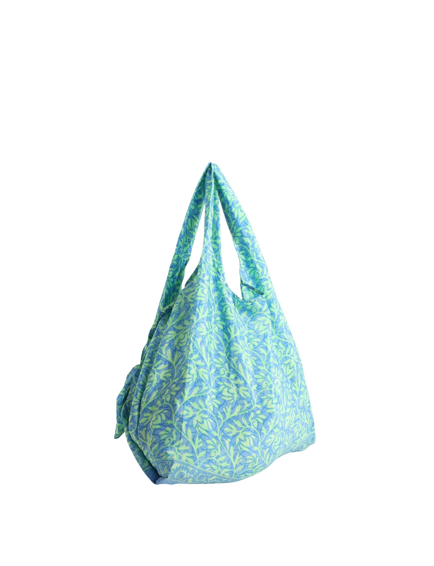 Stay eco-conscious with our Reusable Bag, handmade by Indian artisans from pre-loved saris. Silky and lightweight, this foldaway bag is perfect for your on-the-go lifestyle. Each piece is a unique statement of ethical fashion, embracing sustainability and style.