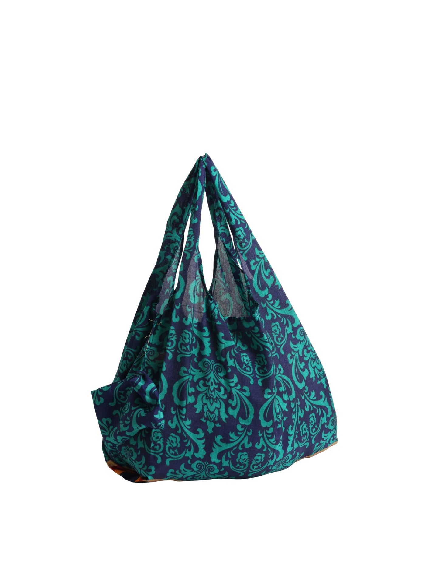 Stay eco-conscious with our Reusable Bag, handmade by Indian artisans from pre-loved saris. Silky and lightweight, this foldaway bag is perfect for your on-the-go lifestyle. Each piece is a unique statement of ethical fashion, embracing sustainability and style.