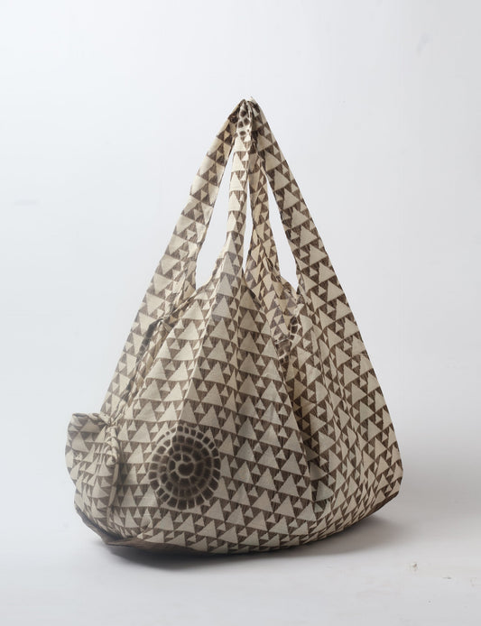 Stay eco-conscious with our Reusable Bag, handmade by Indian artisans from pre-loved saris. Silky and lightweight, this foldaway bag is perfect for your on-the-go lifestyle. Each piece is a unique statement of ethical fashion, embracing sustainability and style.