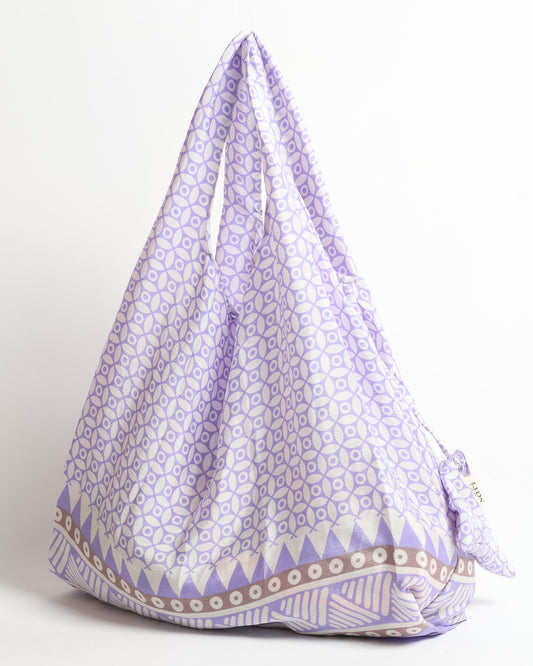 Stay eco-conscious with our Reusable Bag, handmade by Indian artisans from pre-loved saris. Silky and lightweight, this foldaway bag is perfect for your on-the-go lifestyle. Each piece is a unique statement of ethical fashion, embracing sustainability and style.