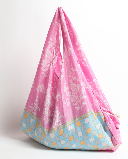 Stay eco-conscious with our Reusable Bag, handmade by Indian artisans from pre-loved saris. Silky and lightweight, this foldaway bag is perfect for your on-the-go lifestyle. Each piece is a unique statement of ethical fashion, embracing sustainability and style.