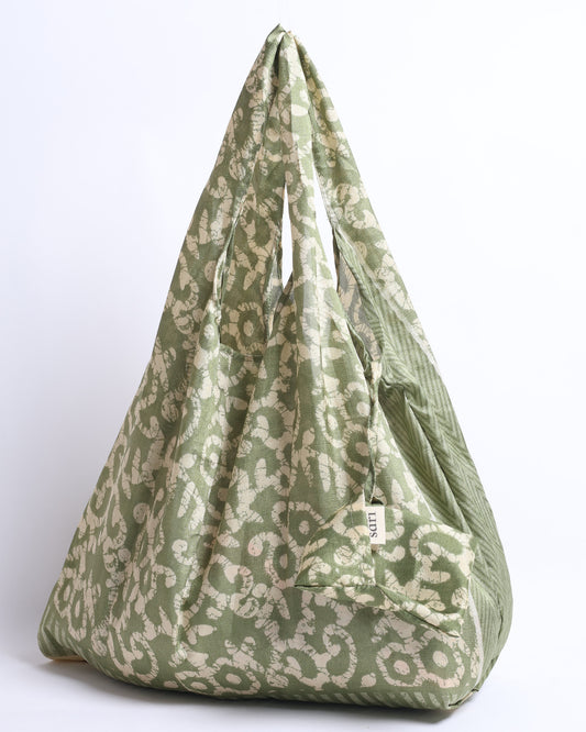 Stay eco-conscious with our Reusable Bag, handmade by Indian artisans from pre-loved saris. Silky and lightweight, this foldaway bag is perfect for your on-the-go lifestyle. Each piece is a unique statement of ethical fashion, embracing sustainability and style.