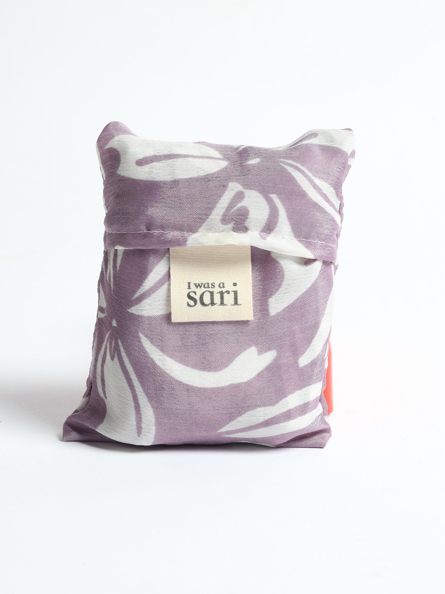 Stay eco-conscious with our Reusable Bag, handmade by Indian artisans from pre-loved saris. Silky and lightweight, this foldaway bag is perfect for your on-the-go lifestyle. Each piece is a unique statement of ethical fashion, embracing sustainability and style.