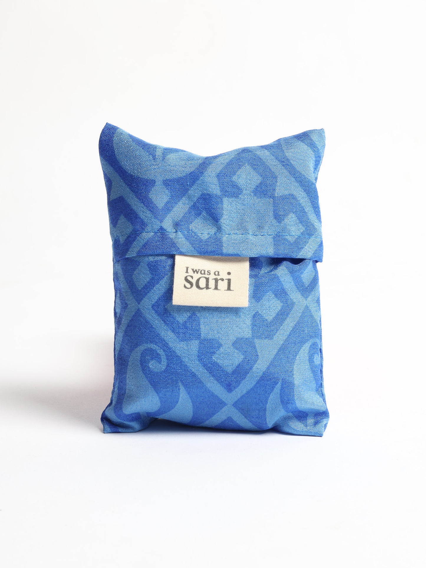 Stay eco-conscious with our Reusable Bag, handmade by Indian artisans from pre-loved saris. Silky and lightweight, this foldaway bag is perfect for your on-the-go lifestyle. Each piece is a unique statement of ethical fashion, embracing sustainability and style.