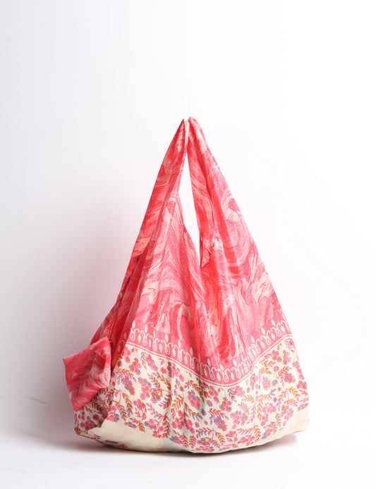 Stay eco-conscious with our Reusable Bag, handmade by Indian artisans from pre-loved saris. Silky and lightweight, this foldaway bag is perfect for your on-the-go lifestyle. Each piece is a unique statement of ethical fashion, embracing sustainability and style.