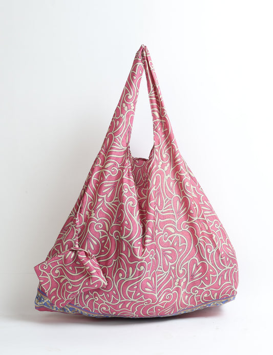 Stay eco-conscious with our Reusable Bag, handmade by Indian artisans from pre-loved saris. Silky and lightweight, this foldaway bag is perfect for your on-the-go lifestyle. Each piece is a unique statement of ethical fashion, embracing sustainability and style.