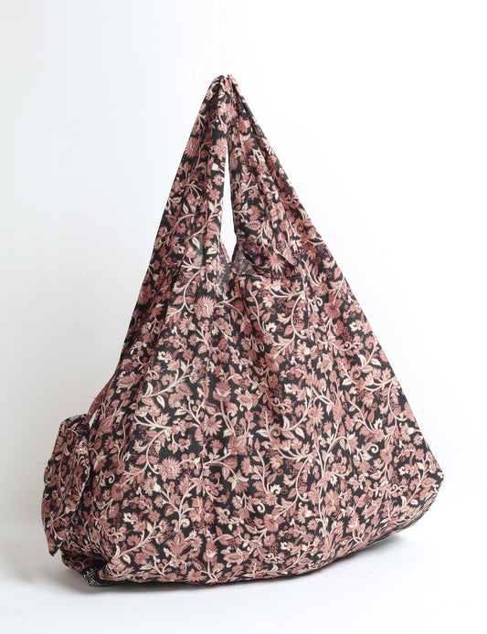 Stay eco-conscious with our Reusable Bag, handmade by Indian artisans from pre-loved saris. Silky and lightweight, this foldaway bag is perfect for your on-the-go lifestyle. Each piece is a unique statement of ethical fashion, embracing sustainability and style.