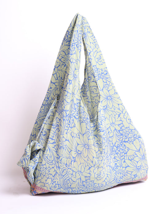 Stay eco-conscious with our Reusable Bag, handmade by Indian artisans from pre-loved saris. Silky and lightweight, this foldaway bag is perfect for your on-the-go lifestyle. Each piece is a unique statement of ethical fashion, embracing sustainability and style.