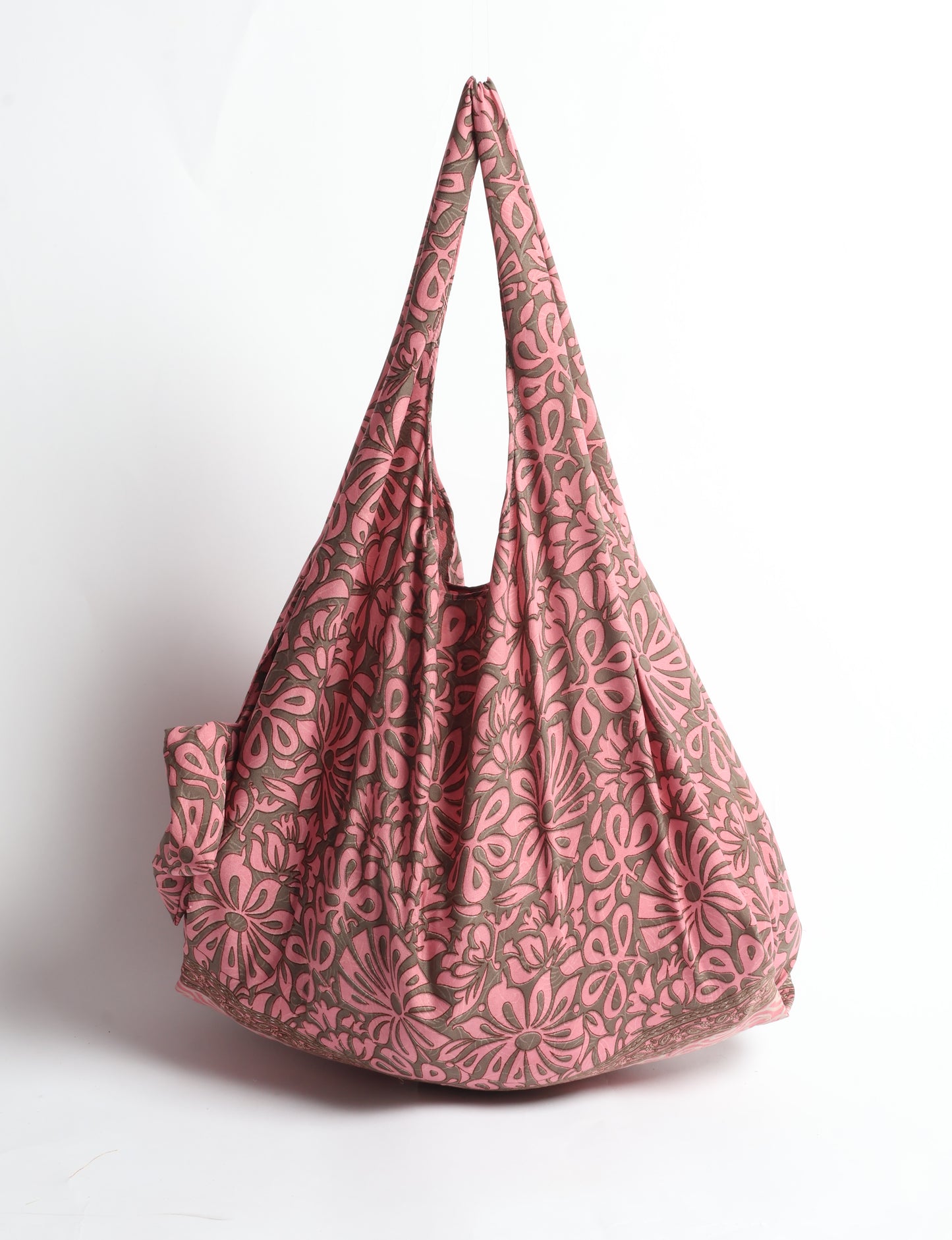 Stay eco-conscious with our Reusable Bag, handmade by Indian artisans from pre-loved saris. Silky and lightweight, this foldaway bag is perfect for your on-the-go lifestyle. Each piece is a unique statement of ethical fashion, embracing sustainability and style.