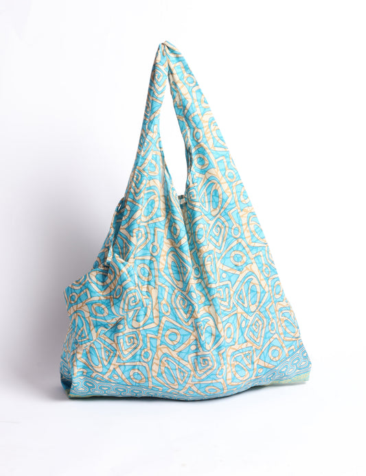 Stay eco-conscious with our Reusable Bag, handmade by Indian artisans from pre-loved saris. Silky and lightweight, this foldaway bag is perfect for your on-the-go lifestyle. Each piece is a unique statement of ethical fashion, embracing sustainability and style.