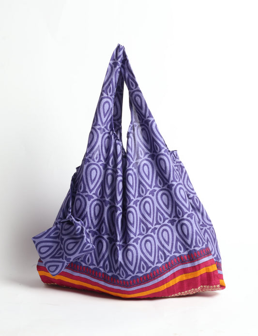 Stay eco-conscious with our Reusable Bag, handmade by Indian artisans from pre-loved saris. Silky and lightweight, this foldaway bag is perfect for your on-the-go lifestyle. Each piece is a unique statement of ethical fashion, embracing sustainability and style.