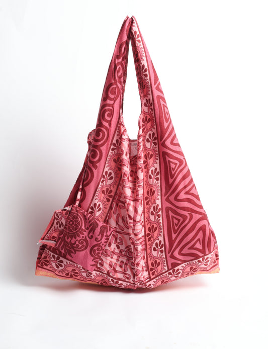 Stay eco-conscious with our Reusable Bag, handmade by Indian artisans from pre-loved saris. Silky and lightweight, this foldaway bag is perfect for your on-the-go lifestyle. Each piece is a unique statement of ethical fashion, embracing sustainability and style.