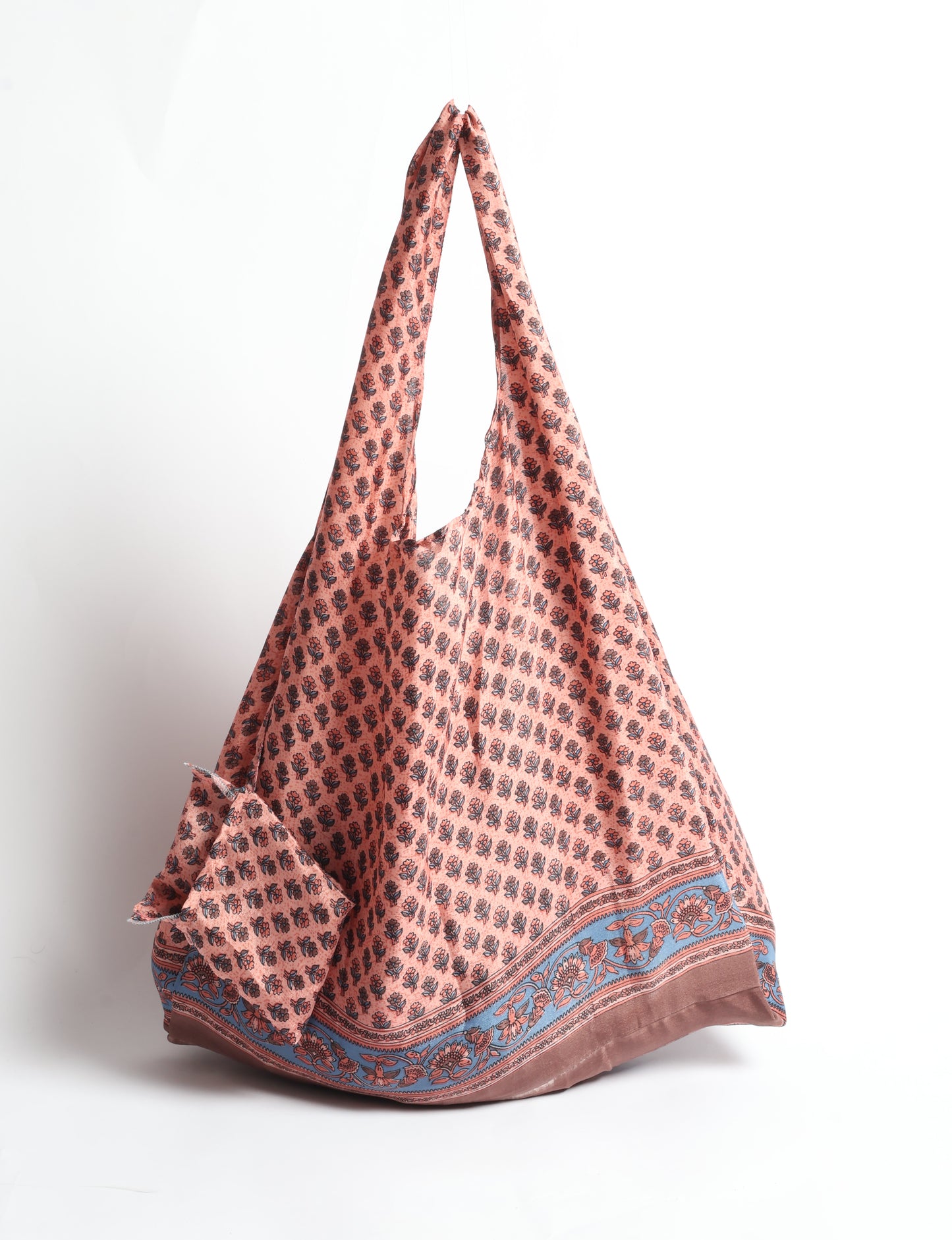 Stay eco-conscious with our Reusable Bag, handmade by Indian artisans from pre-loved saris. Silky and lightweight, this foldaway bag is perfect for your on-the-go lifestyle. Each piece is a unique statement of ethical fashion, embracing sustainability and style.