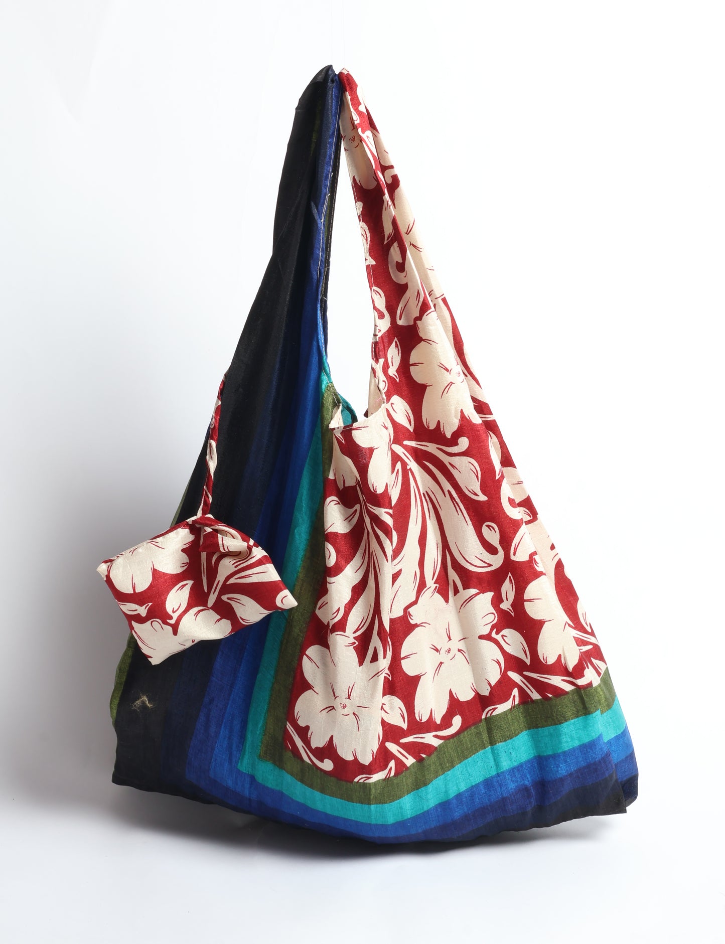 Stay eco-conscious with our Reusable Bag, handmade by Indian artisans from pre-loved saris. Silky and lightweight, this foldaway bag is perfect for your on-the-go lifestyle. Each piece is a unique statement of ethical fashion, embracing sustainability and style.