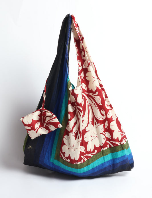Stay eco-conscious with our Reusable Bag, handmade by Indian artisans from pre-loved saris. Silky and lightweight, this foldaway bag is perfect for your on-the-go lifestyle. Each piece is a unique statement of ethical fashion, embracing sustainability and style.