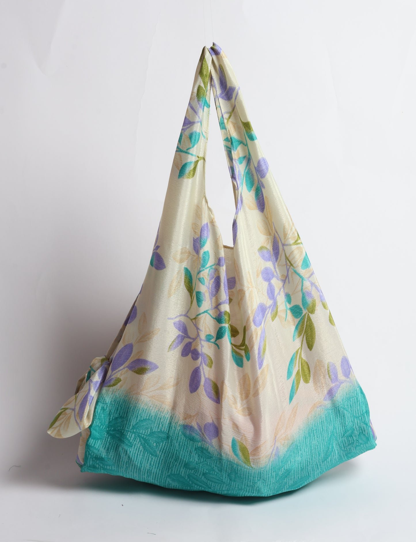 Stay eco-conscious with our Reusable Bag, handmade by Indian artisans from pre-loved saris. Silky and lightweight, this foldaway bag is perfect for your on-the-go lifestyle. Each piece is a unique statement of ethical fashion, embracing sustainability and style.