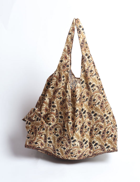 Stay eco-conscious with our Reusable Bag, handmade by Indian artisans from pre-loved saris. Silky and lightweight, this foldaway bag is perfect for your on-the-go lifestyle. Each piece is a unique statement of ethical fashion, embracing sustainability and style.