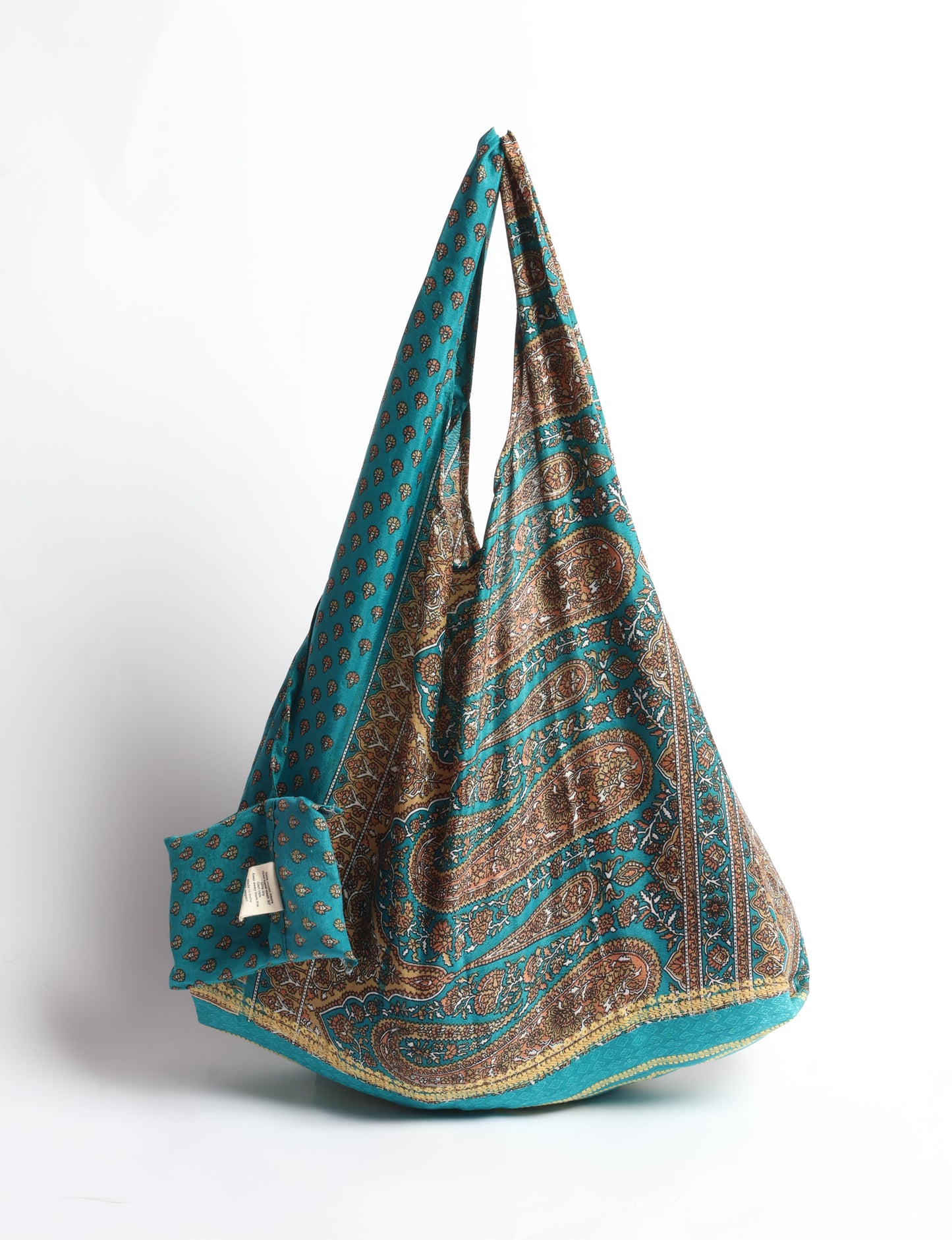 Stay eco-conscious with our Reusable Bag, handmade by Indian artisans from pre-loved saris. Silky and lightweight, this foldaway bag is perfect for your on-the-go lifestyle. Each piece is a unique statement of ethical fashion, embracing sustainability and style.