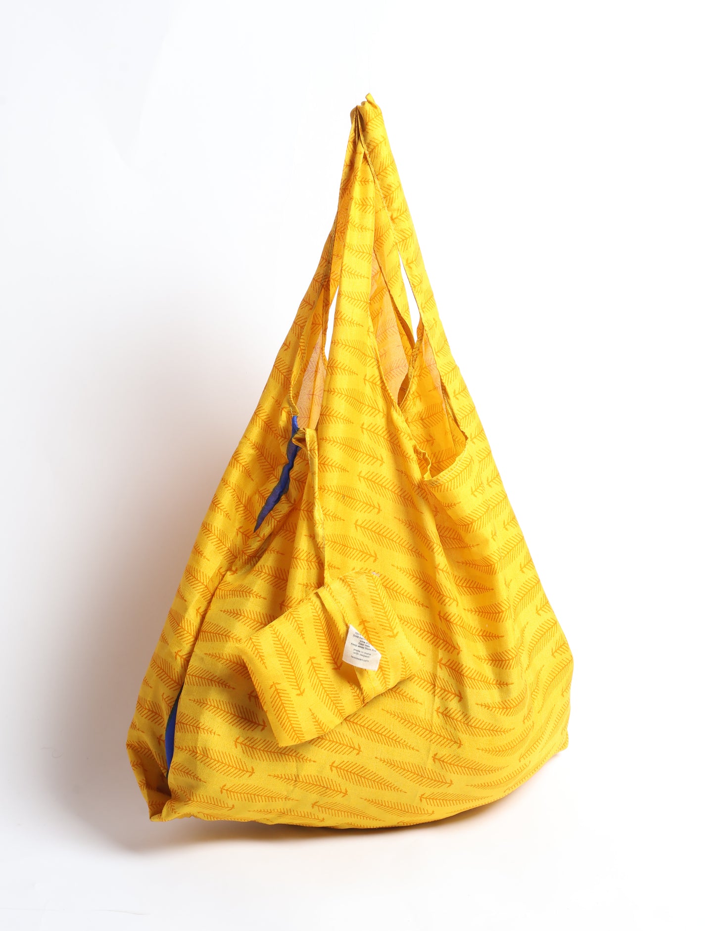 Stay eco-conscious with our Reusable Bag, handmade by Indian artisans from pre-loved saris. Silky and lightweight, this foldaway bag is perfect for your on-the-go lifestyle. Each piece is a unique statement of ethical fashion, embracing sustainability and style.
