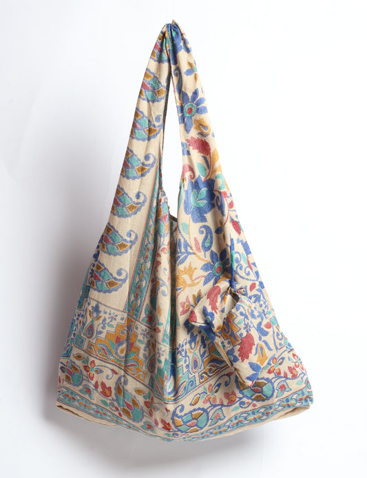 Stay eco-conscious with our Reusable Bag, handmade by Indian artisans from pre-loved saris. Silky and lightweight, this foldaway bag is perfect for your on-the-go lifestyle. Each piece is a unique statement of ethical fashion, embracing sustainability and style.