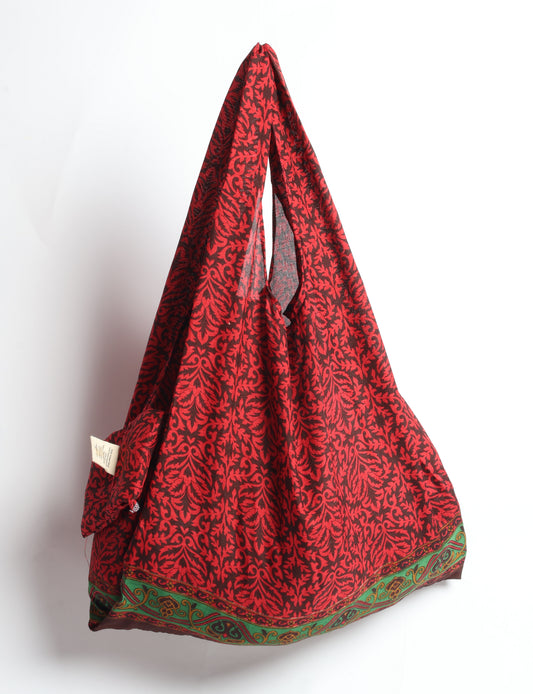 Stay eco-conscious with our Reusable Bag, handmade by Indian artisans from pre-loved saris. Silky and lightweight, this foldaway bag is perfect for your on-the-go lifestyle. Each piece is a unique statement of ethical fashion, embracing sustainability and style.