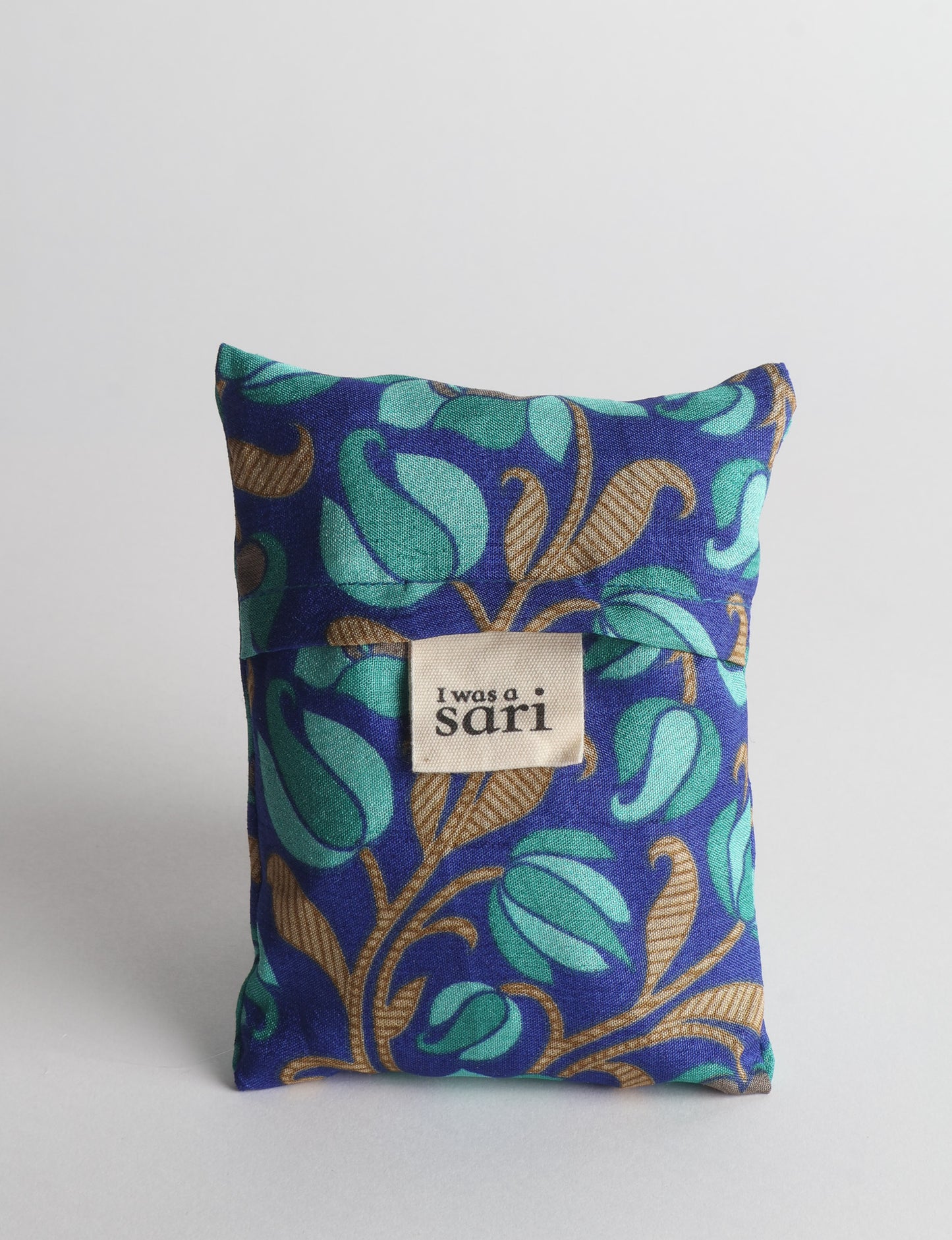 Stay eco-conscious with our Reusable Bag, handmade by Indian artisans from pre-loved saris. Silky and lightweight, this foldaway bag is perfect for your on-the-go lifestyle. Each piece is a unique statement of ethical fashion, embracing sustainability and style.